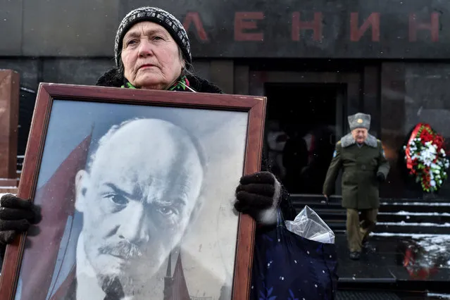 A Russian Communist Party supporter carries a portrait of the late Soviet leader Vladimir Lenin as she takes part in a memorial ceremony to mark the 92st anniversary of his death in Red Square, in central Moscow on January 21, 2016. (Photo by Kirill Kudryavtsev/AFP Photo)