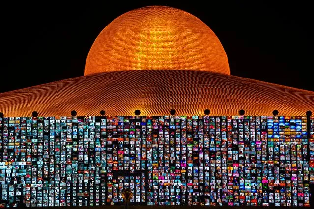 Screens show devotees gathering via the Zoom application during Vesak Day, an annual celebration of Buddha's birth, enlightenment, and death at the Dhammakaya temple amid the coronavirus disease (COVID-19) pandemic in Pathum Thani province, Thailand, May 26, 2021. (Photo by Athit Perawongmetha/Reuters)