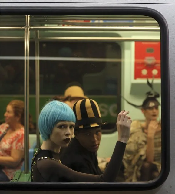 Models present creations in a subway station during Sao Paulo Fashion Week in Sao Paulo October 27, 2013. (Photo by Paulo Whitaker/Reuters)