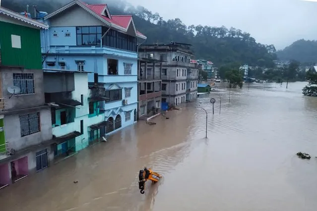 This handout photograph released by the Indian Army and taken on October 4, 2023, shows a flooded street in Lachen Valley, in India's Sikkim state following a flash flood caused by intense rainfall. The Indian army said Wednesday that 23 soldiers were missing after a powerful flash flood caused by intense rainfall tore through a valley in the mountainous northeast Sikkim state. (Photo by Indian Army/AFP Photo)
