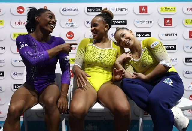 US' Simone Biles, Brasil's Rebeca Andrade and Brasil's Flavia Saraiva wait for the results after competing in the Women's Floor Final during the 52nd FIG Artistic Gymnastics World Championships, in Antwerp, northern Belgium, on October 8, 2023. (Photo by Yves Herman/Reuters)