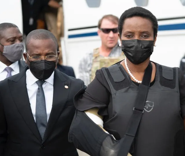 In this handout photo released by Haiti's Secretary of State for Communication, Haiti's first lady Martine Moise, wearing a bullet proof vest and her right arm in a sling, arrives at the Toussaint Louverture International Airport, in Port-au-Prince, Haiti, Saturday, July 17, 2021. Martine Moise, the wife of assassinated President Jovenel Moise, who was injured in the July 7 attack at their private home, returned to the Caribbean nation on Saturday following her release from a Miami hospital. (Photo by Haiti's Secretary of State for Communication Photo via AP Photo)
