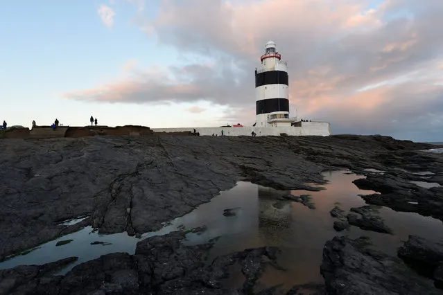 The 800-year-old Hook Head lighthouse is seen on New Year's day after the Claiming of the Waters ceremony in Hook Head, Ireland January 1, 2017. (Photo by Clodagh Kilcoyne/Reuters)