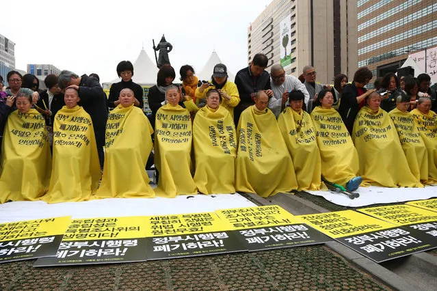 Relatives of missing loved ones in the Sewol ferry sinking having their heads shaved during a protest on Gwanghwanmun Square in Seoul, South Korea, 02 April 2015. Relatives took part in a protest demanding the vessel's recovery and the truth behind the accident on 16 April 2014, which left more than 300 dead. (Photo by Yang Ji-Woong/EPA)