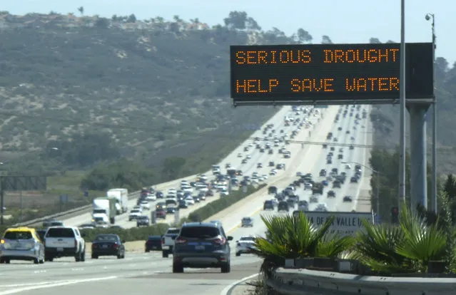 A digital traffic sign usually used for commuter travel information informs travelers southbound on interstate highway 5 to conserve water as they pass through Del Mar, September 10, 2014. (Photo by Mike Blake/Reuters)