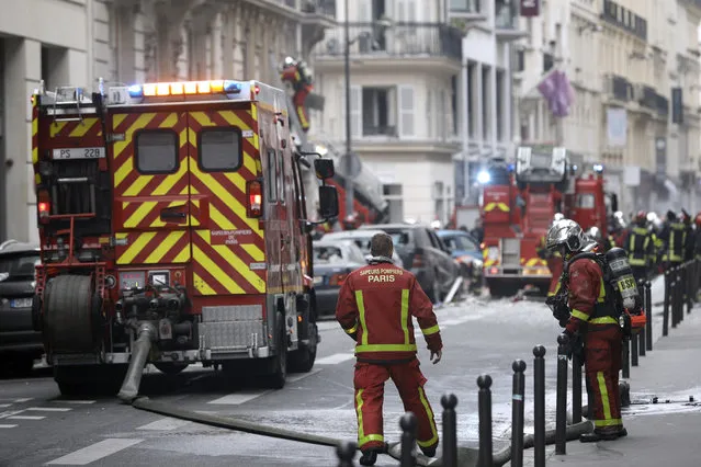 Firefighters work at the scene of a gas leak explosion in Paris, France, Saturday, January 12, 2019. Paris police say several people have been injured in an explosion and fire at a bakery believed caused by a gas leak. (Photo by Kamil Zihnioglu/AP Photo)