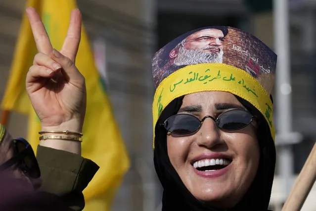 A supporter of the Iranian-backed Hezbollah group flashes victory sign with an Arabic head band that reads:“Martyrs on Jerusalem road”, as she waits the speech of Hezbollah leader Sayyed Hassan Nasrallah during a rally to commemorate Hezbollah fighters who were killed in South Lebanon last few weeks while fighting against the Israeli forces, in Beirut, Lebanon, Friday, November 3, 2023. (Photo by Hussein Malla/AP Photo)