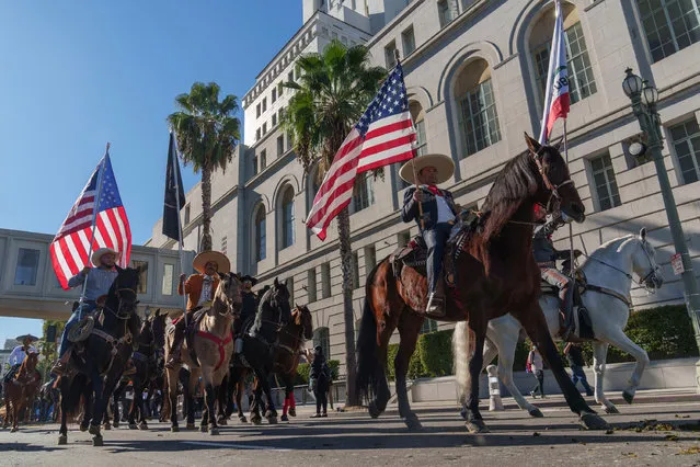 Rodeo supporters ride outside City Hall in Los Angeles as the city council debates a proposal banning rodeos, Tuesday, December 5, 2023. (Photo by Damian Dovarganes/AP Photo)