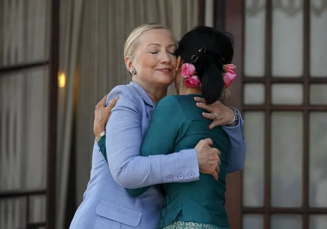 U.S. Secretary of State Hillary Clinton (L) hugs Myanmar's pro-democracy leader Aung San Suu Kyi as they meet at Suu Kyi's house in Yangon, in this December 2, 2011 file photo. (Photo by Soe Zeya Tun/Reuters)
