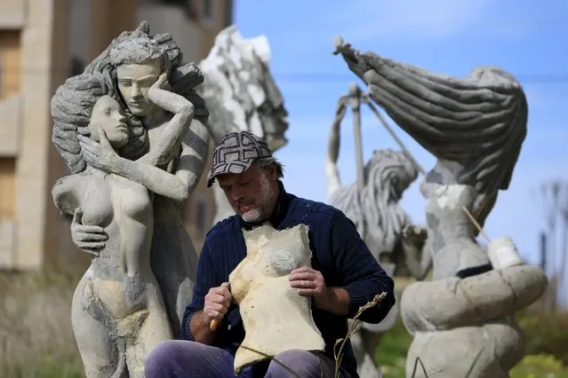 Ukrainian artist Sergey Boyatzi, 56, works on his sculpture in the village of Baqsta, Sidon district, southern Lebanon January 29, 2016. (Photo by Ali Hashisho/Reuters)