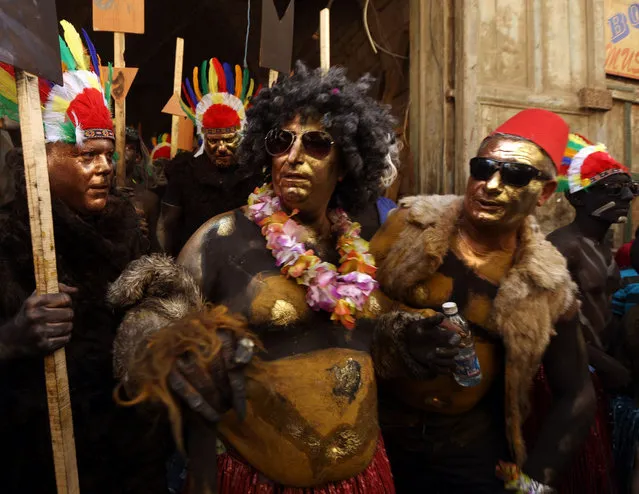 Revelers take part in the Zambo carnival held in the northern Lebanese city of Tripoli on March 13, 2016, to mark the last period of excess on the eve of the Christian Greek Orthodox lent. The inspiration of the annual Zambo celebration is unclear, despite it being a tradition that stretches back over a century to when an emigrant to Brazil returned to his native Tripoli bringing the carnival with him. (Photo by Patrick Baz/AFP Photo)