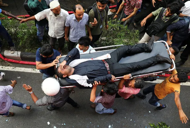 A person is being rescued as fire broke out at a multi-storey commercial building in Dhaka, Bangladesh, March 28, 2019. (Photo by Mohammad Ponir Hossain/Reuters)