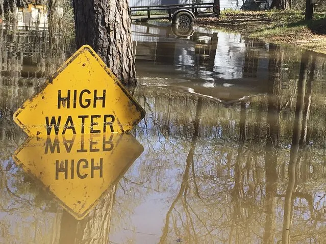 A high water sign is submerged near Lake Bistineau in Webster Parish, Louisiana March 14, 2016. The death toll from storms in Southern U.S. states rose to five as storm-weary residents of Louisiana and Mississippi watched for more flooding on Monday from drenching rains that inundated homes, washed out roads and prompted thousands of rescues. (Photo by Therese Apel/Reuters)