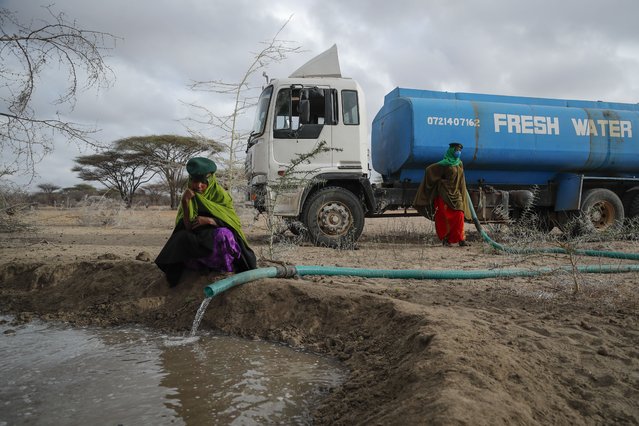 Rangers from the Sabuli Wildlife Conservancy supply water from a tanker for wild animals in the conservancy in Wajir County, Kenya Tuesday, October 26, 2021. (Photo by Brian Inganga/AP Photo)