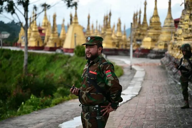 This photo taken on December 12, 2023 shows members of ethnic minority armed group Ta'ang National Liberation Army (TNLA) standing guard in a temple area of a hill camp seized from Myanmar's military in Namhsan Township in Myanmar's northern Shan State. Nestled in the hills of northern Shan state, the town of Namhsan is the latest to fall to Ta'ang National Liberation Army (TNLA) fighters since they launched a surprise offensive launched against Myanmar's junta in October. (Photo by AFP Photo/Stringer)