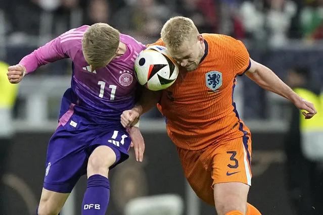 Netherlands' Matthijs de Ligt, right, challenges Germany's Chris Führich during the international friendly soccer match between Germany and Netherlands at the Deutsche Bank Park in Frankfurt, Germany on Tuesday, March 26, 2024. (Photo by Martin Meissner/AP Photo)