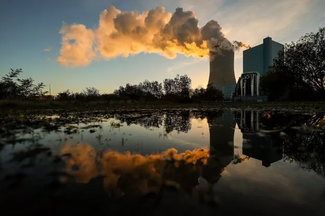 The steaming coal-fired power plant Datteln 4 is reflected in the water of the Dortmund-Ems-Canal in Datteln, Germany, 02 November 2021. The production of carbon-based energy is one of the main sources of environmental pollution worldwide and the black coal consuming plant was controversial already before launched in May 2020. Germany, a coal extracting country, is striving to abolish coal and nuclear power and to convert to renewable energies, one of the main topics of the COP26. (Photo by Friedemann Vogel/EPA/EFE)