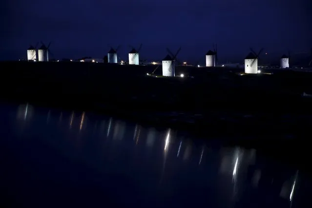 Windmills are seen at dusk in Campo de Criptana, Spain, April 4, 2016. (Photo by Susana Vera/Reuters)