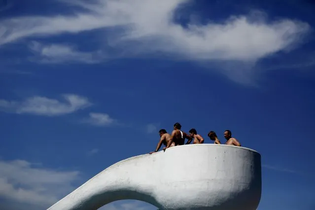 People stand on water slide platform at “Grugabad” open-air swimming pool on a hot summer day in Essen, Germany, June 30, 2015. (Photo by Ina Fassbender/Reuters)