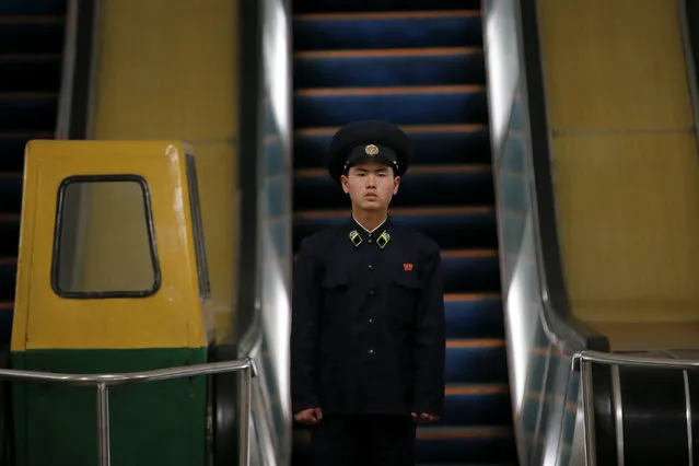 A subway worker stands at the bottom of escalators inside a station in central Pyongyang, North Korea May 7, 2016. (Photo by Damir Sagolj/Reuters)