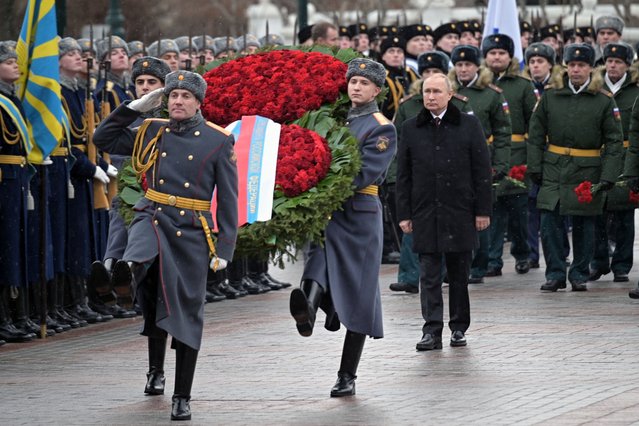 Russian President Vladimir Putin, center right, attends a wreath-laying ceremony at the Tomb of the Unknown Soldier, near the Kremlin Wall during the national celebrations of the “Defender of the Fatherland Day” in Moscow, Russia, Wednesday, February 23, 2022. The Defenders of the Fatherland Day, celebrated in Russia on Feb. 23, honors the nation's military and is a nationwide holiday. (Photo by Alexei Nikolsky, Kremlin Pool Photo via AP Photo)