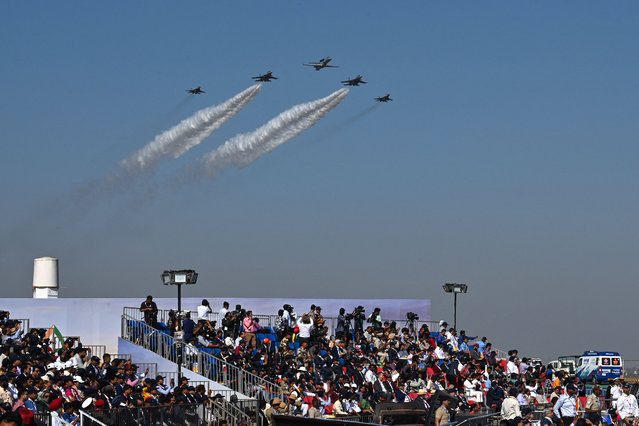 Indian Air Force (IAF) aircrafts fly past during the inaugural day of the 14th edition of 'Aero India 2023' airshow at the Yelahanka air force station in Bengaluru on February 13, 2023. (Photo by Manjunath Kiran/AFP Photo)