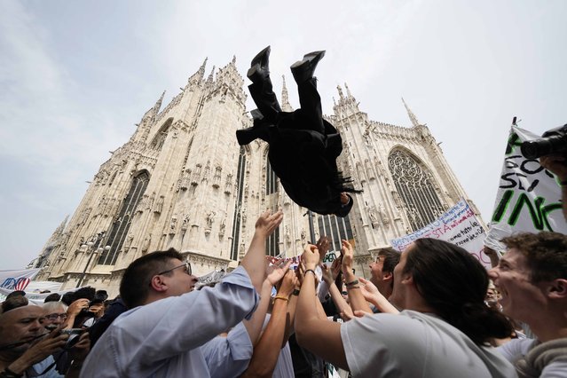 A newly ordered Catholic priest is launched in the air by friends and family outside the Duomo Cathedral after his ordination ceremony in Milan, Italy, Saturday, June 8, 2024. (Photo by Luca Bruno/AP Photo)