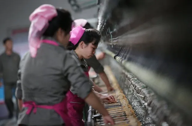 North Korean women working in the Kim Jong Suk silk mill are seen during a press tour on Monday, May 9, 2016, in Pyongyang, North Korea. Only about 30 of the more than 100 invited journalists brought into the country to cover the biggest political event in North Korea in decades have been allowed inside the meeting hall to see the proceedings, Monday. Officials have kept the foreign media busy with trips around Pyongyang to show them places North Korea wants them to see. (Photo by Wong Maye-E/AP Photo)