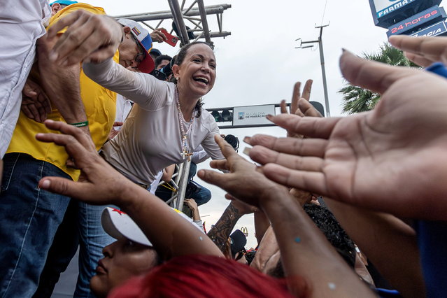 Venezuelan opposition leader Maria Corina Machado greets supporters during a rally in Maracaibo, Venezuela, 02 May 2024. Machado reiterated that the 28 July presidential elections will put an end to socialism in the country, ruled by Chavism since 1999. (Photo by Henry Chirinos/EPA)