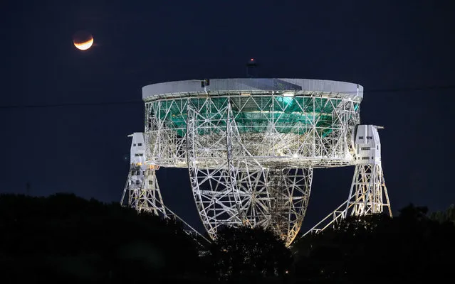 A partial lunar eclipse is visible above the Jodrell Bank observatory in Cheshire, England on July 16, 2019. (Photo by Peter Byrne/PA Wire Press Association)