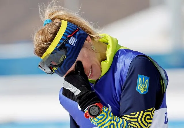 Gold medalist Oleksandra Kononova of Team Ukraine reacts during the Women's Middle Distance Free Technique Standing flower ceremony on day eight of the Beijing 2022 Winter Paralympics at Zhangjiakou National Biathlon Centre on March 12, 2022 in Zhangjiakou, China. (Photo by Issei Kato/Reuters)