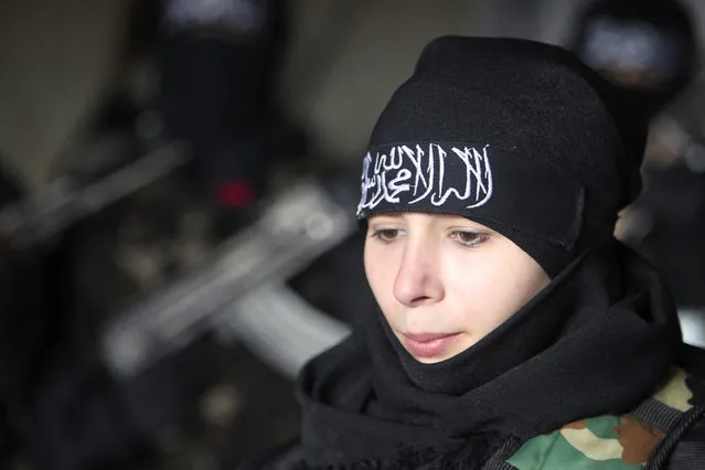 Um Jaafar, a woman fighter in the Free Syrian Army, rests while undergoing military training with other women in Aleppo February 17, 2013. Um Jaafar was a women's hairdresser before the revolution and was trained by her husband Abu Jaafar, a Sawt al-Haq battalion commander, to be part of Sawt al-Haq. (Photo by Muzaffar Salman/Reuters)