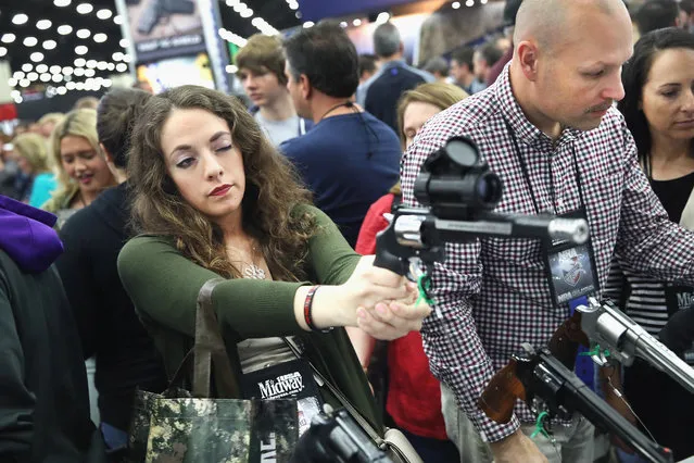 Gun enthusiasts look over Smith & Wesson pistols at the NRA Annual Meetings & Exhibits on May 21, 2016 in Louisville, Kentucky. (Photo by Scott Olson/Getty Images)