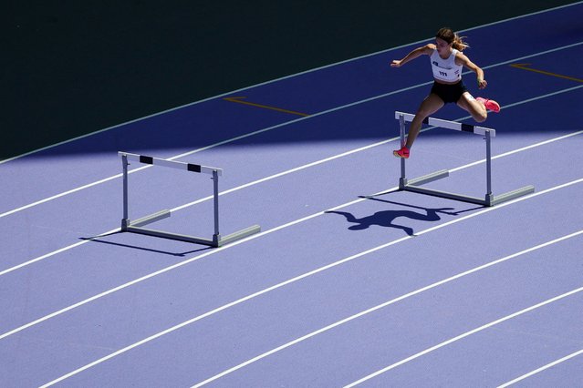 A regional athlete competes during a test event for the Olympics Games at the Stade de France, in Saint-Denis on June 25, 2024. The Stade de France will host track and field events and Rugby sevens game during the Paris 2024 Olympic Games. (Photo by Geoffroy Van der Hasselt/AFP Photo)