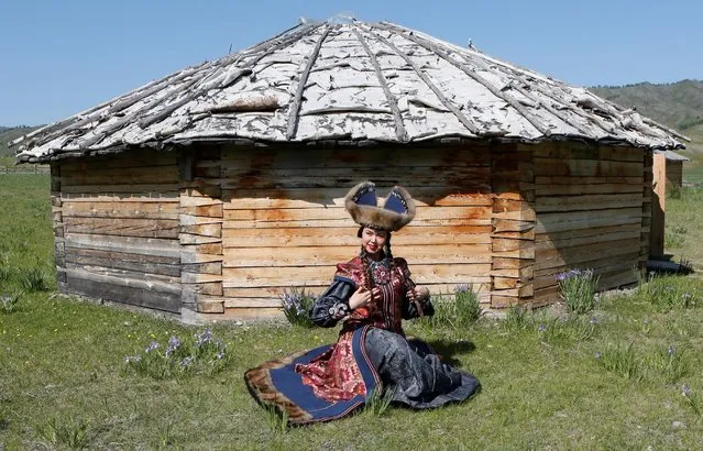 A model of the “Altyr” fashion theatre, dressed in a Khakas national costume, poses during a photo session, as a part of the rehearsal for the Tun-Pairam traditional holiday (The Holiday of the First Milk) celebration at a museum preserve outside Kazanovka village near Abakan in the Republic of Khakassia, Russia, May 28, 2016. (Photo by Ilya Naymushin/Reuters)