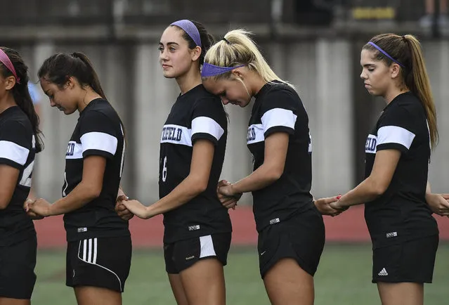 Battlefield Bobcats midfielder Madison Southwick (10) rests her head on her teammate Battlefield Bobcats midfielder Bianca Robson's (6) shoulder during the playing of the National Anthem before the Virginia 6A North Region Soccer girls' semifinal game between the Battlefield Bobcats and the Yorktown Patriots on June 1, 2016. The Battlefield Bobcats defeated the Yorktown Patriots 3-1 to advance to the finals. (Photo by Toni L. Sandys/The Washington Post)