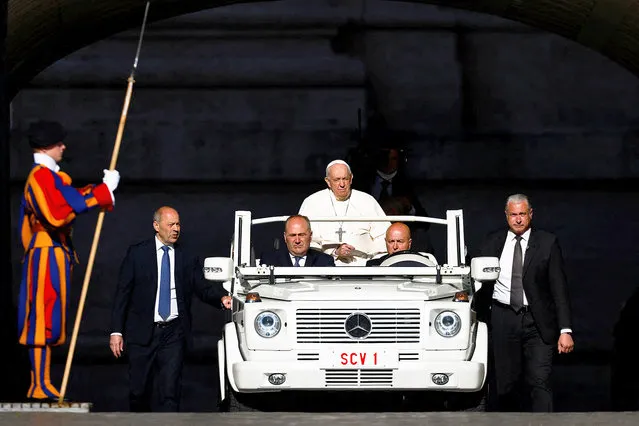 Pope Francis rides on the pope mobile as he arrives for the weekly general audience in Saint Peter's Square at the Vatican, April 27, 2022. (Photo by Guglielmo Mangiapane/Reuters)
