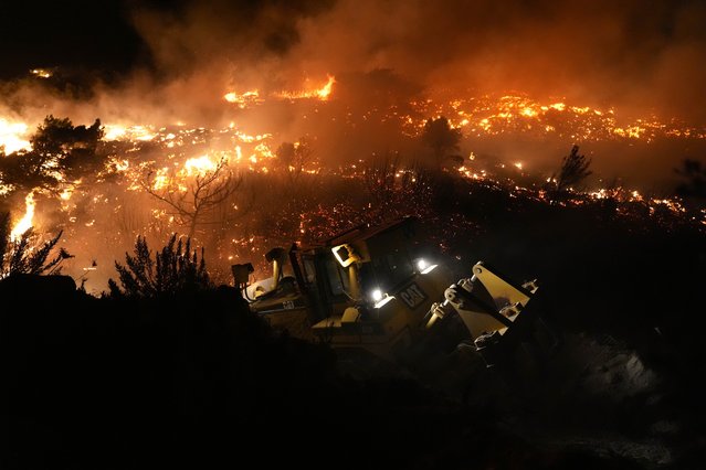 Firefighters continue to work to extinguish the forest fire that broke out in Balikliova in Izmir's Urla district, Turkiye on August 18, 2024. (Photo by Berkan Cetin/Anadolu via Getty Images)