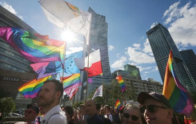 Thousands of Warsaw residents with rainbow flags walk in a colorful annual Equality Parade to show their support for sexual minority groups  in Warsaw, Poland, Saturday, June 11, 2016. (Photo by Czarek Sokolowski/AP Photo)