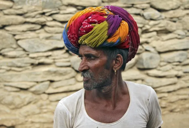 A man wearing a traditional turban looks on in Devmali village in the desert state of Rajasthan, India, June 16, 2016. (Photo by Himanshu Sharma/Reuters)