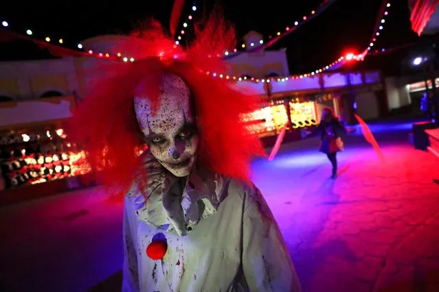A participant wearing a costume and make-up attends a Halloween parade at Walibi park in Wavre, Belgium, October 25, 2019. (Photo by Yves Herman/Reuters)