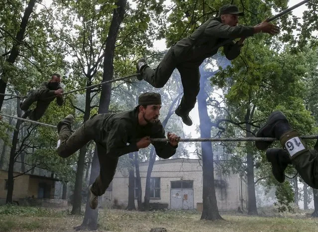 New volunteers for the Ukrainian interior ministry's “Azov” battalion take part in tests before heading to frontlines in eastern Ukraine, at the battalion's training centre in Kiev, Ukraine, August 14, 2015. (Photo by Gleb Garanich/Reuters)