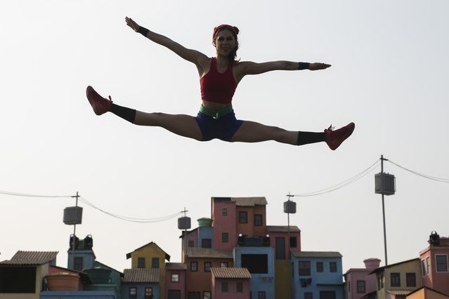 A Brazilian artist from the Ser Favela group performs on a stage with favela scenery at the Rock in Rio music festival in Rio de Janeiro, Brazil, Saturday, September 14, 2024. (Photo by Bruna Prado/AP Photo)