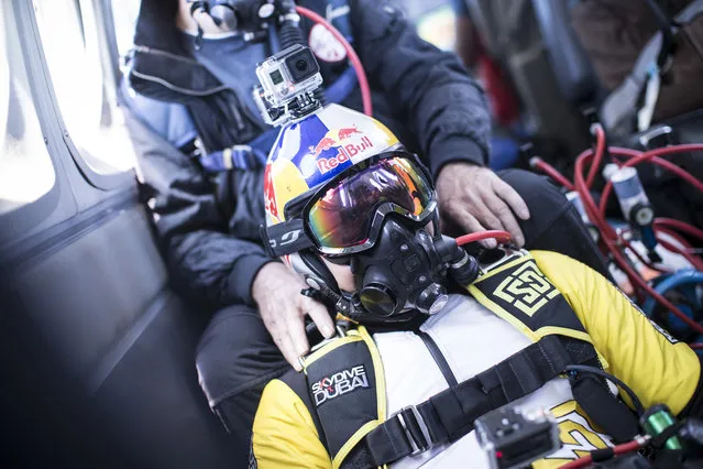 Fred Fugen and Vincent Reffet seen inside the plane before jumping at 33,000 feet (10 km) above the Mont Blanc, French Alps on May 31, 2014. Fearless skydivers jump from an altitude of 10,000 meters above the largest mountain in Europe. Frederic Fugen, 34, and Vincent Reffet, 29, leapt from a plane in the freezing skies above Mont-Blanc in the French Alps. The jump is from such a height the pictures show the curvature of the earth. (Photo by Dominique Daher/Barcroft Media)