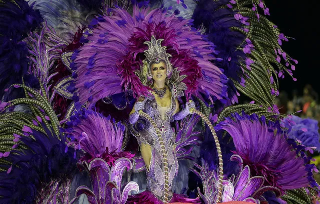 A dancer from the Mocidade Alegre samba school performs on a float during a carnival parade in Sao Paulo, Brazil, Sunday, February 23, 2020. (Photo by Andre Penner/AP Photo)