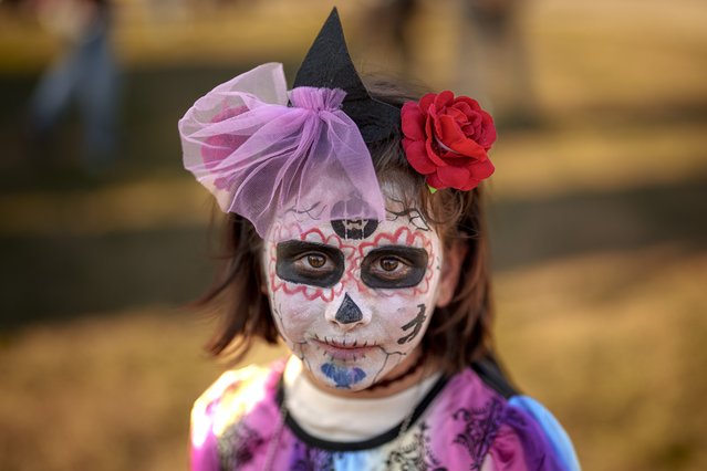 Daniela, wearing make up and a costume made by her mother Daniela, poses for a photograph at the West Side Hallo Fest, a Halloween festival in Bucharest, Romania, Saturday, October 26, 2024. (Photo by Andreea Alexandru/AP Photo)