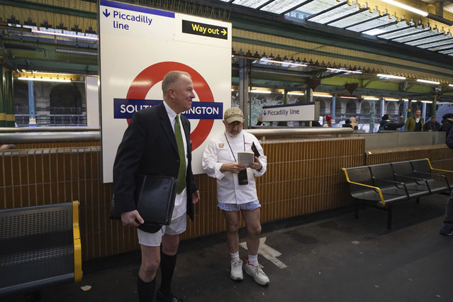 Two men wait for a tube at South Kensington station as they take part in the annual event “No Trousers Tube Ride” in London, Sunday, January 12, 2025. (Photo by Alberto Pezzali/AP Photo)