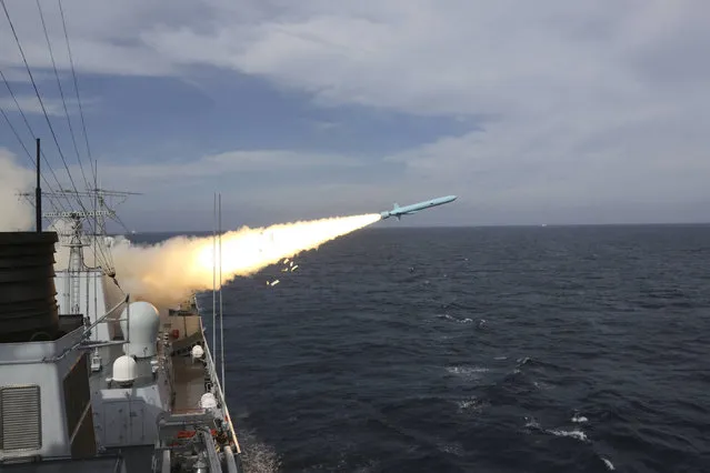 In this Monday, August 1, 2016 photo released by Xinhua News Agency, a missile is launched from a guided-missile destroyer during a live ammunition drill in the East China Sea. China's navy has fired dozens of missiles and torpedoes during exercises in the East China Sea that come amid heightened maritime tensions in the region, underscoring Beijing's determination to back up its sovereignty claims with force if needed. The live-fire drills that began Monday follow China's strident rejection of an international arbitration panel's ruling last month that invalidated Beijing's claims to a vast swath of the South China Sea. (Photo by Wu Dengfeng/Xinhua via AP Photo)