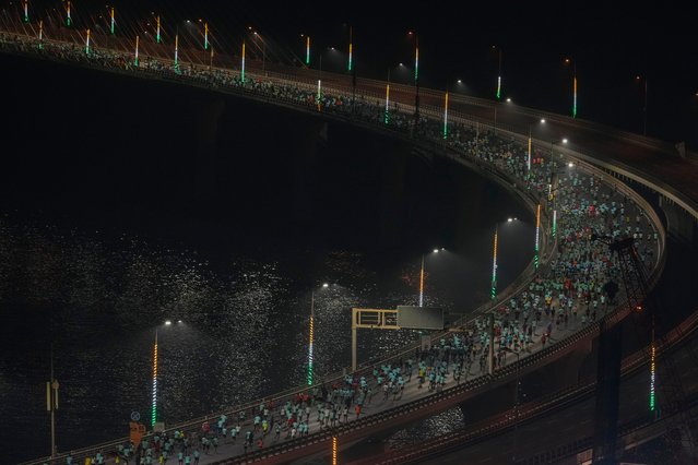 Runners compete along the Bandra-Worli sea link over the Arabian Sea during the Tata Mumbai Marathon in Mumbai, India, Sunday, January 19, 2025. (Photo by Rafiq Maqbool/AP Photo)