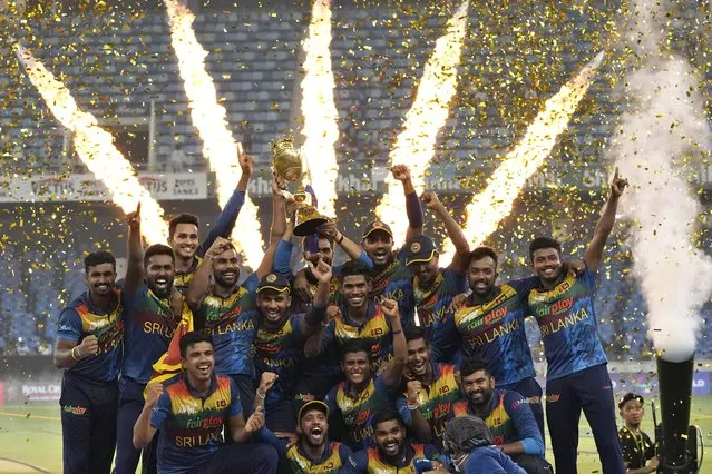 Sri Lankan players celebrate with the winners trophy after their win in the T20 cricket Asia Cup final match against Pakistan, in Dubai, United Arab Emirates, Sunday, September 11, 2022. (Photo by Anjum Naveed/AP Photo)